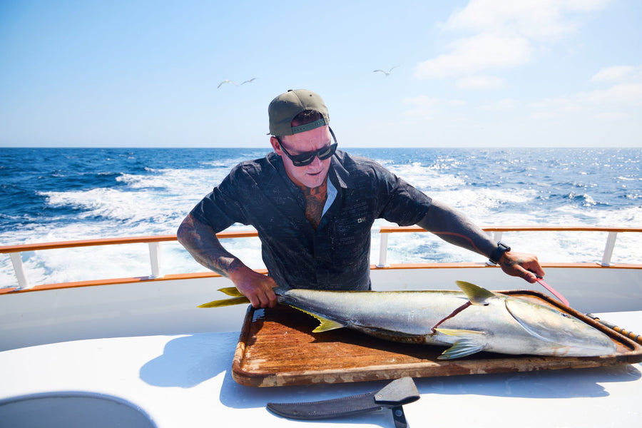 Capt. Duane Diego filleting a yellowtail on the boat